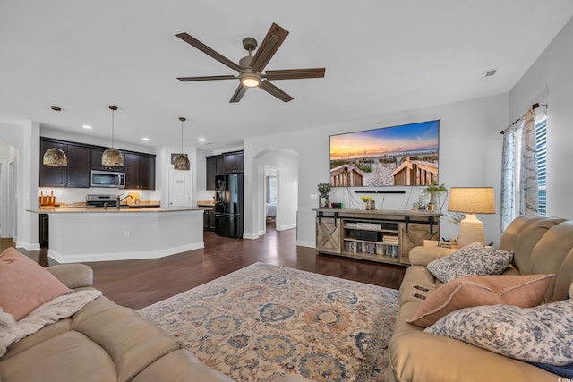 321 Sanctuary Ct, Myrtle Beach, SC 29588 - living room featuring arched walkways, recessed lighting, a ceiling fan, and dark wood-style flooring