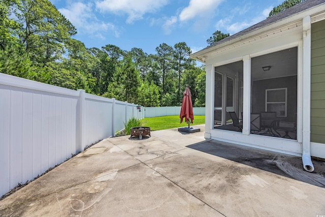 321 Sanctuary Ct, Myrtle Beach, SC 29588 - fenced backyard with a sunroom, a fire pit, and a patio