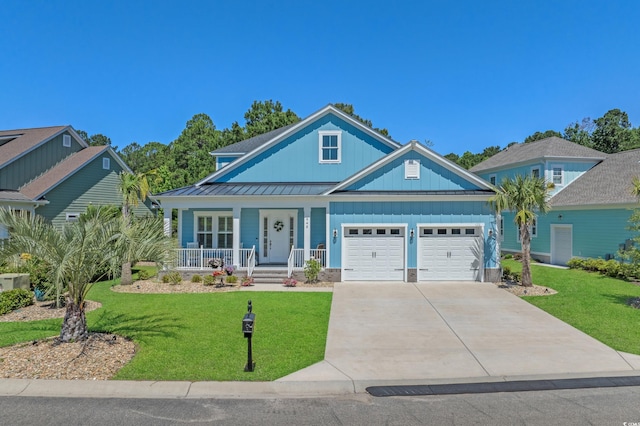 945 Waterbridge Blvd, Myrtle Beach, SC 29579 - view of front of home featuring a garage, board and batten siding, a porch, driveway, and a front yard