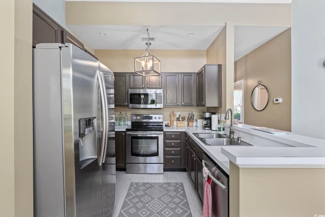 2150 Longwood Lakes Dr Unit 2150, Myrtle Beach, SC 29579 - kitchen featuring appliances with stainless steel finishes, a chandelier, light countertops, decorative light fixtures, and dark brown cabinets