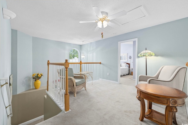 2150 Longwood Lakes Dr Unit 2150, Myrtle Beach, SC 29579 - sitting room with an upstairs landing, a textured ceiling, a ceiling fan, and carpet