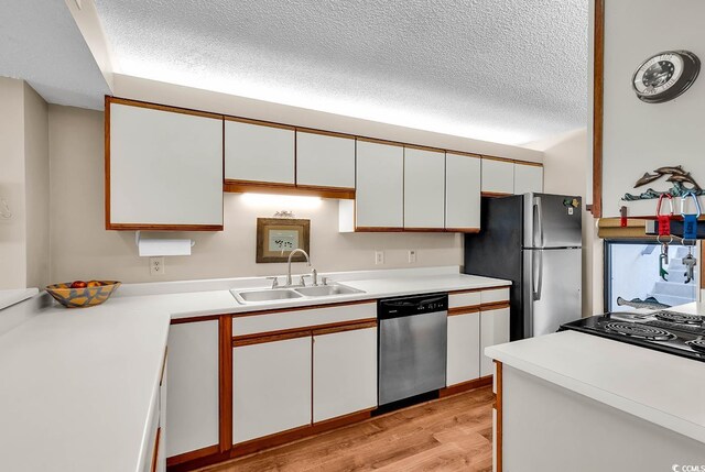 741 Retreat Beach Cir Unit B-1-A, Pawleys Island, SC 29585 - kitchen featuring stainless steel appliances, white cabinets, a textured ceiling, and light wood-style floors