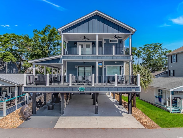 6001-Q10 S Kings Hwy, Myrtle Beach, SC 29575 - coastal inspired home featuring board and batten siding, ceiling fan, a carport, a balcony, and concrete driveway