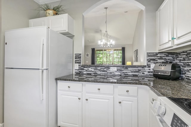 6015 Catalina Dr Unit 634, North Myrtle Beach, SC 29582 - kitchen featuring freestanding refrigerator, backsplash, white cabinetry, and a chandelier