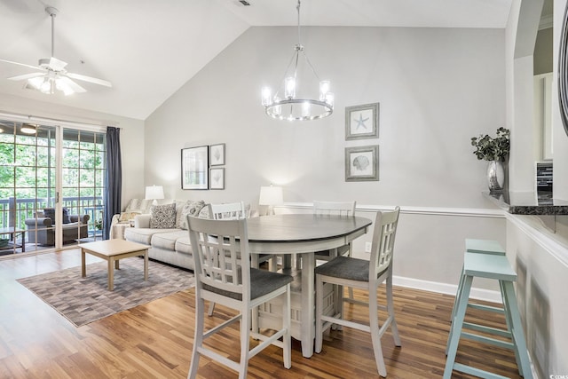 6015 Catalina Dr Unit 634, North Myrtle Beach, SC 29582 - dining room featuring wood finished floors, high vaulted ceiling, ceiling fan, and a chandelier