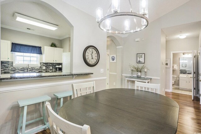 6015 Catalina Dr Unit 634, North Myrtle Beach, SC 29582 - dining space with arched walkways, dark wood finished floors, and a chandelier
