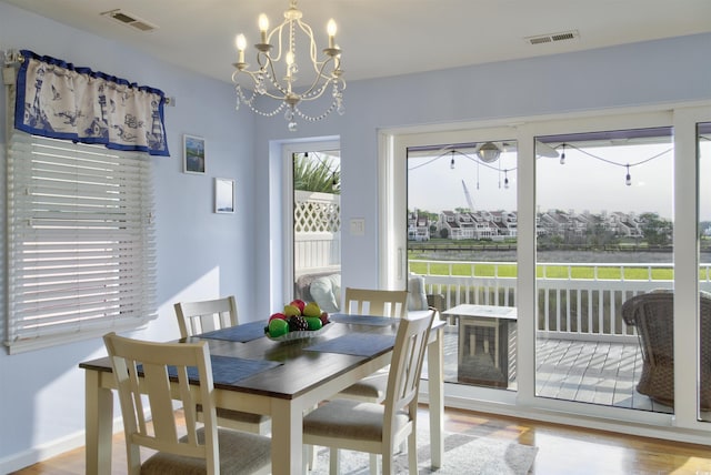 4525 Landing Rd, Little River, SC 29566 - dining space with a chandelier and wood finished floors