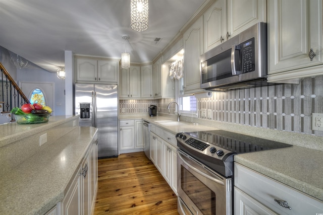 4525 Landing Rd, Little River, SC 29566 - kitchen with appliances with stainless steel finishes, backsplash, wood finished floors, and light countertops