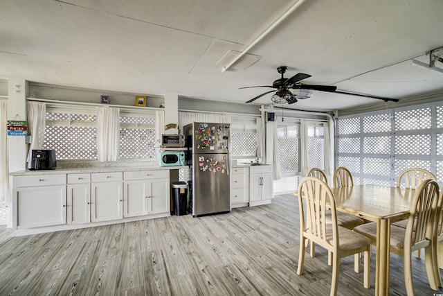 4525 Landing Rd, Little River, SC 29566 - dining room featuring ceiling fan and light wood-style flooring