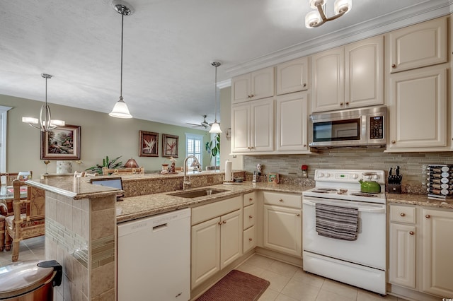 901 W Port Dr Unit 305, North Myrtle Beach, SC 29582 - kitchen with white appliances, a peninsula, light tile patterned floors, light stone counters, and cream cabinets