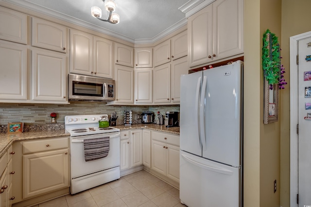 901 W Port Dr Unit 305, North Myrtle Beach, SC 29582 - kitchen featuring white appliances, decorative backsplash, light tile patterned flooring, and cream cabinets