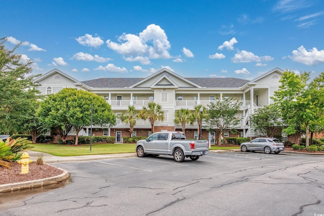 5825 Catalina Dr Unit 125, North Myrtle Beach, SC 29582 - view of building exterior with uncovered parking
