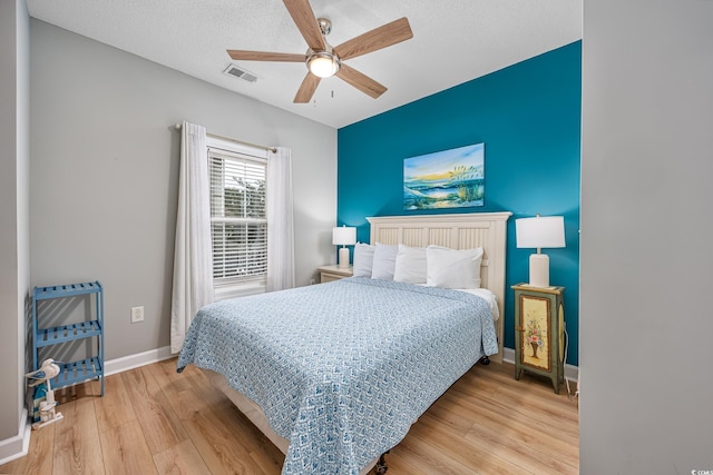 5825 Catalina Dr Unit 125, North Myrtle Beach, SC 29582 - bedroom featuring wood finished floors, ceiling fan, and a textured ceiling