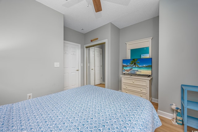 5825 Catalina Dr Unit 125, North Myrtle Beach, SC 29582 - bedroom featuring light wood-style floors, a textured ceiling, ceiling fan, and a closet