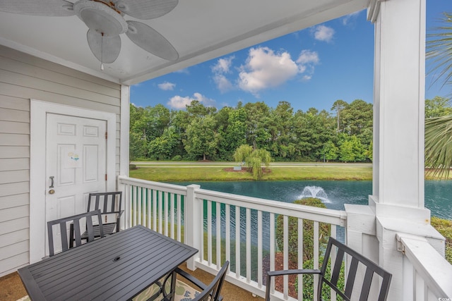 5825 Catalina Dr Unit 125, North Myrtle Beach, SC 29582 - balcony featuring a water view, ceiling fan, view of scattered trees, and outdoor dining area