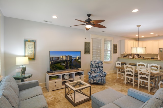 4901 N Market St, North Myrtle Beach, SC 29582 - living area featuring a ceiling fan, recessed lighting, and light stone finish floors