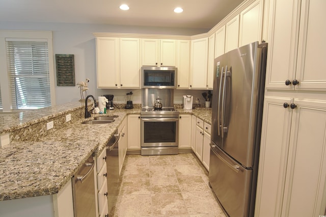 4901 N Market St, North Myrtle Beach, SC 29582 - kitchen with stainless steel appliances, recessed lighting, a peninsula, and light stone countertops