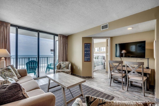 9400 Shore Dr Unit 617, Myrtle Beach, SC 29572 - living area with floor to ceiling windows, wood finished floors, and a textured ceiling