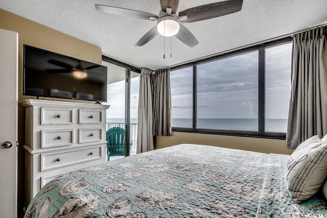 9400 Shore Dr Unit 617, Myrtle Beach, SC 29572 - bedroom featuring access to outside, a textured ceiling, and a ceiling fan