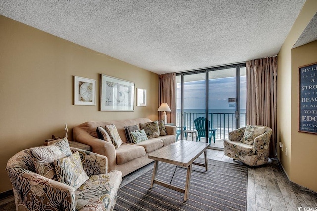 9400 Shore Dr Unit 617, Myrtle Beach, SC 29572 - living room with wood finished floors, expansive windows, and a textured ceiling
