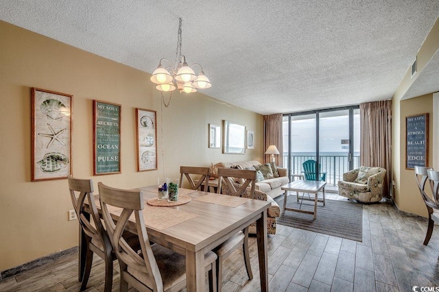 9400 Shore Dr Unit 617, Myrtle Beach, SC 29572 - dining space with floor to ceiling windows, wood finished floors, a textured ceiling, and a chandelier