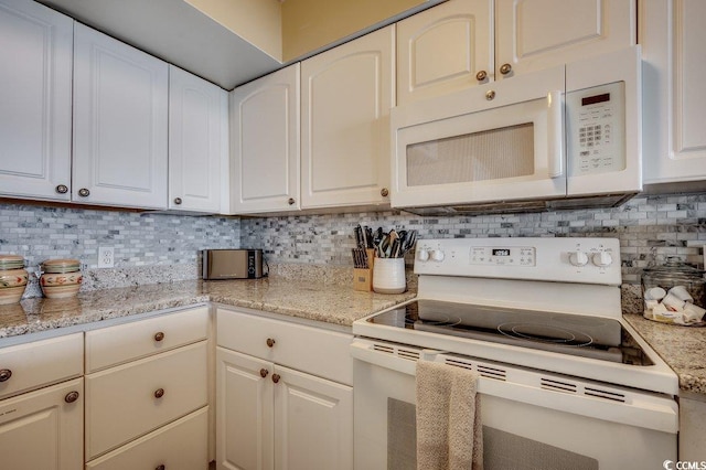 9400 Shore Dr Unit 617, Myrtle Beach, SC 29572 - kitchen featuring white appliances, tasteful backsplash, white cabinets, and light stone countertops