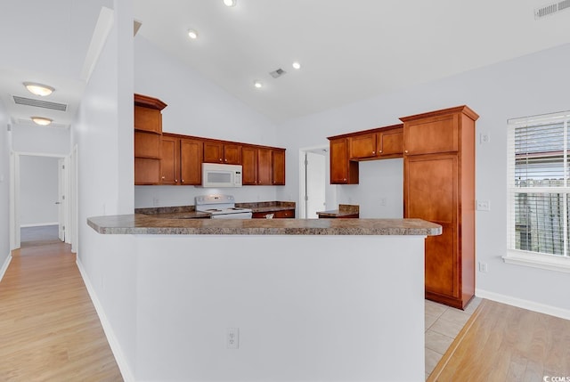 1636 Stuart Square Cir, Myrtle Beach, SC 29577 - kitchen with white appliances, open shelves, light wood-style flooring, a peninsula, and high vaulted ceiling