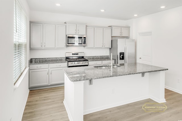 547 Pacific Commons Dr, Surfside Beach, SC 29575 - kitchen featuring stainless steel appliances, healthy amount of natural light, a kitchen island with sink, light stone counters, and recessed lighting