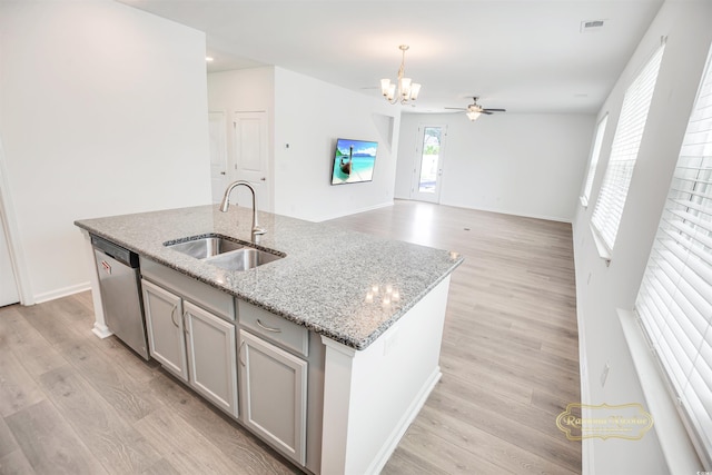 547 Pacific Commons Dr, Surfside Beach, SC 29575 - kitchen with stainless steel dishwasher, an island with sink, a chandelier, gray cabinetry, and light wood-type flooring