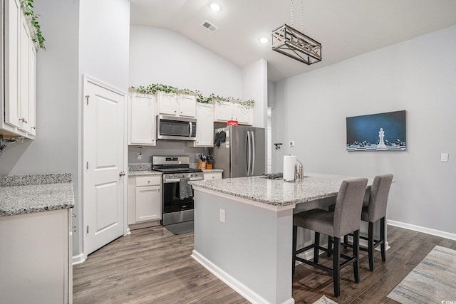 1807 Berkley Village Loop, Myrtle Beach, SC 29579 - kitchen with appliances with stainless steel finishes, white cabinets, dark wood-type flooring, a kitchen island, and high vaulted ceiling