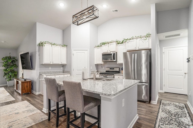 1807 Berkley Village Loop, Myrtle Beach, SC 29579 - kitchen featuring appliances with stainless steel finishes, high vaulted ceiling, white cabinetry, a center island with sink, and dark wood finished floors