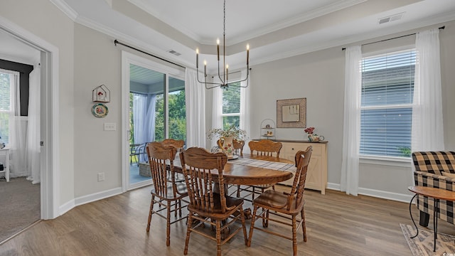 598 Cascade Loop, Little River, SC 29566 - dining space featuring a chandelier, light wood finished floors, crown molding, and a raised ceiling