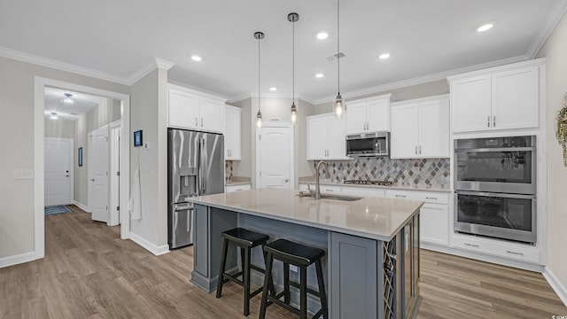 598 Cascade Loop, Little River, SC 29566 - kitchen with appliances with stainless steel finishes, tasteful backsplash, white cabinetry, light countertops, and a kitchen breakfast bar