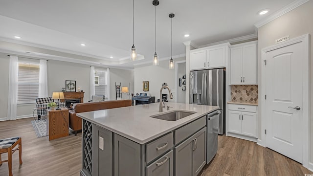 598 Cascade Loop, Little River, SC 29566 - kitchen with gray cabinets, appliances with stainless steel finishes, crown molding, light wood-style flooring, and backsplash