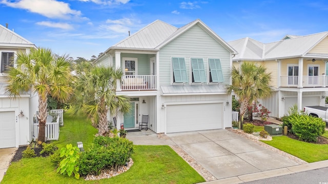 540 Chanted Dr, Murrells Inlet, SC 29576 - beach home with a garage, a front yard, driveway, a metal roof, and a balcony