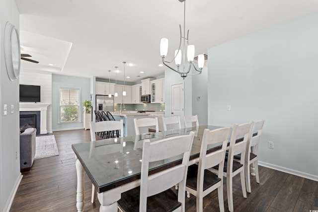 540 Chanted Dr, Murrells Inlet, SC 29576 - dining room with dark wood-style flooring, a ceiling fan, recessed lighting, a chandelier, and a glass covered fireplace