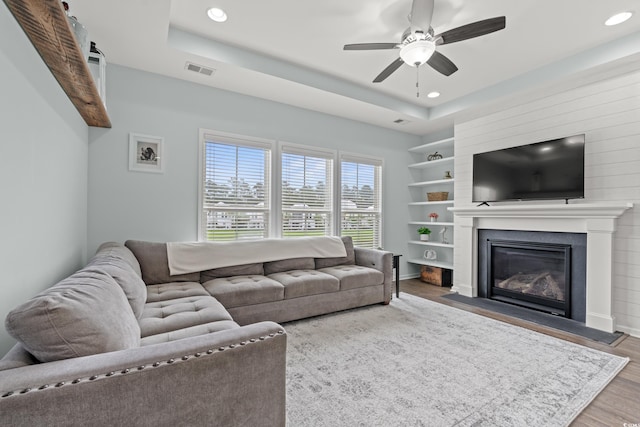 540 Chanted Dr, Murrells Inlet, SC 29576 - living area featuring recessed lighting, ceiling fan, a large fireplace, a raised ceiling, and wood finished floors