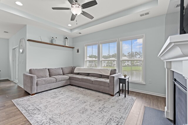 540 Chanted Dr, Murrells Inlet, SC 29576 - living room featuring a raised ceiling, ceiling fan, wood finished floors, a fireplace with flush hearth, and recessed lighting