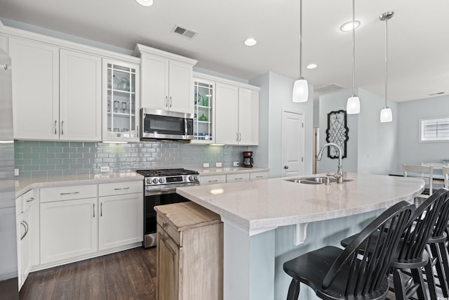 540 Chanted Dr, Murrells Inlet, SC 29576 - kitchen featuring stainless steel appliances, dark wood-type flooring, light stone countertops, glass insert cabinets, and white cabinetry