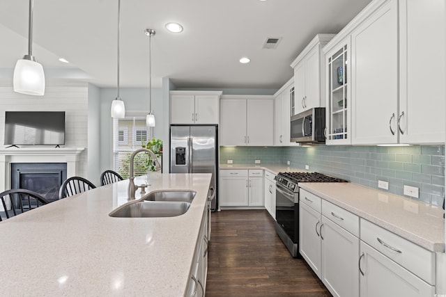540 Chanted Dr, Murrells Inlet, SC 29576 - kitchen with stainless steel appliances, recessed lighting, decorative light fixtures, white cabinets, and light stone counters