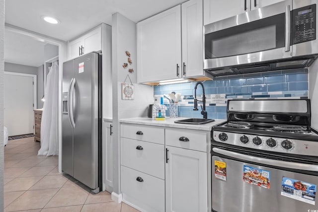 2001 S Ocean Blvd Unit 1408, Myrtle Beach, SC 29577 - kitchen featuring stainless steel appliances, light countertops, light tile patterned floors, and white cabinets