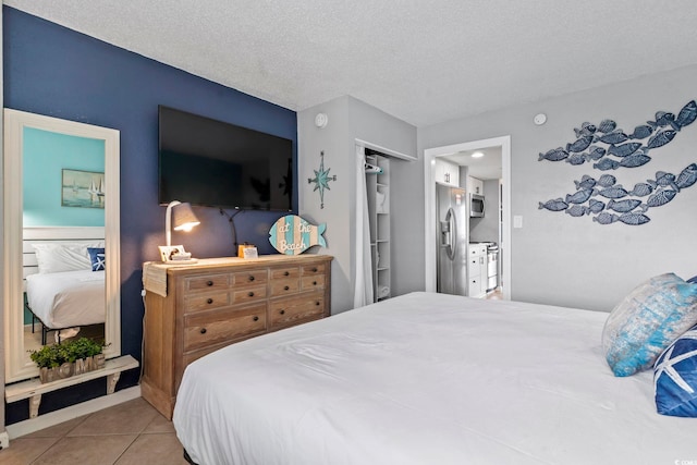 2001 S Ocean Blvd Unit 1408, Myrtle Beach, SC 29577 - bedroom with stainless steel refrigerator with ice dispenser, tile patterned floors, and a textured ceiling