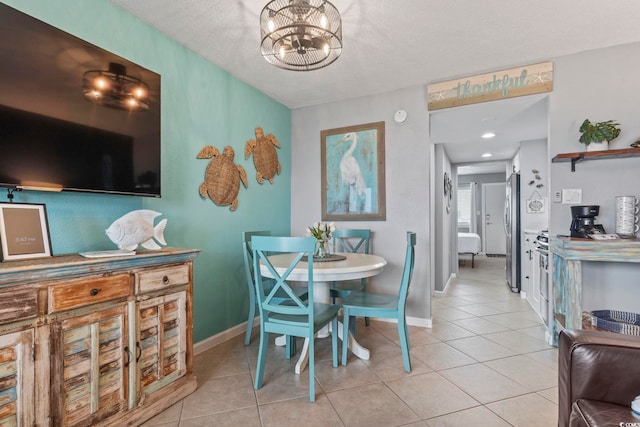 2001 S Ocean Blvd Unit 1408, Myrtle Beach, SC 29577 - dining area featuring a chandelier, light tile patterned floors, and a textured ceiling