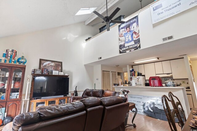 4344 Spa Dr Unit 605, Little River, SC 29566 - living area with high vaulted ceiling, a ceiling fan, wood finished floors, and a skylight