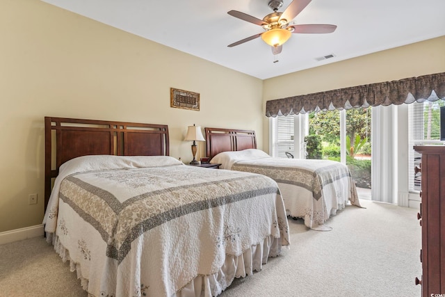 1009 World Tour Blvd Unit 105, Myrtle Beach, SC 29579 - bedroom featuring light carpet, access to outside, multiple windows, and ceiling fan