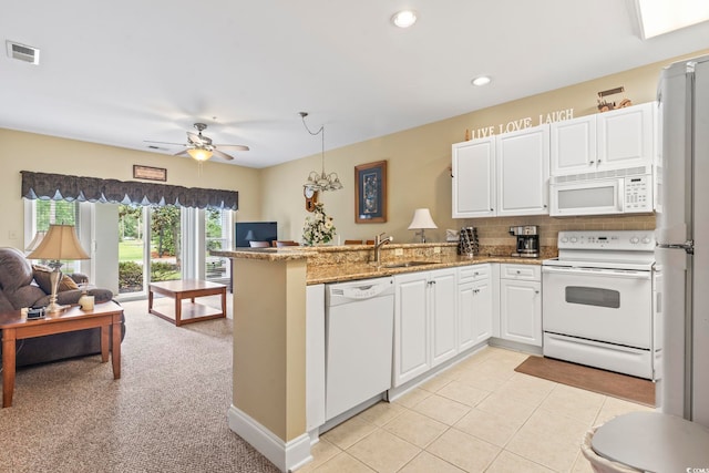 1009 World Tour Blvd Unit 105, Myrtle Beach, SC 29579 - kitchen featuring white appliances, open floor plan, a peninsula, white cabinetry, and recessed lighting