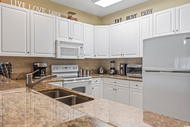 1009 World Tour Blvd Unit 105, Myrtle Beach, SC 29579 - kitchen with white appliances, backsplash, white cabinets, and light stone counters
