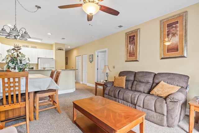 1009 World Tour Blvd Unit 105, Myrtle Beach, SC 29579 - living room with light colored carpet, a chandelier, and ceiling fan