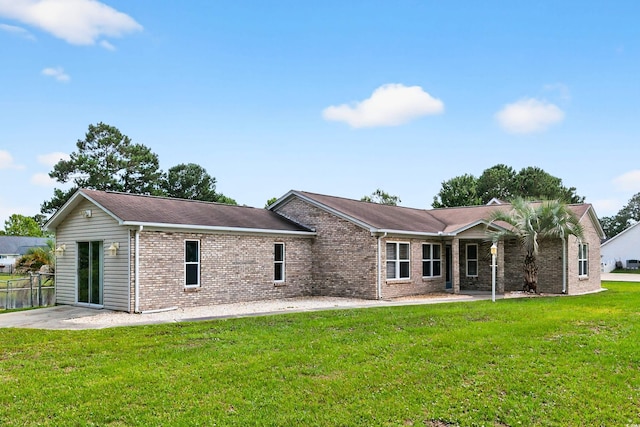131 Pine Lake Cir, Ocean Isle Beach, NC 28469 - back of property with brick siding and a patio