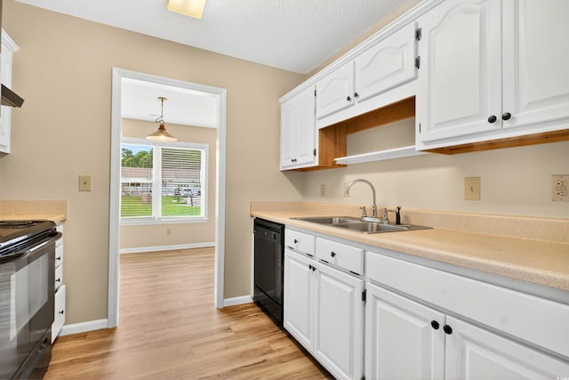 131 Pine Lake Cir, Ocean Isle Beach, NC 28469 - kitchen featuring black appliances, white cabinets, light wood finished floors, and light countertops